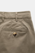 Close-up rear view of Brunello Cucinelli Chinos 'Italian Fit' sage, showing garment-dyed elasticated cotton twill, back buttoned pocket, and belt loops.