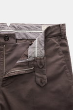 Brunello Cucinelli Chinos 'Italian Fit' grey brown shown from a close-up top front angle with open zip, buttons, and waistband details, crafted from elasticated cotton twill with a soft feel, garment-dyed fabric, regular fit, tapered cut, French pockets, 