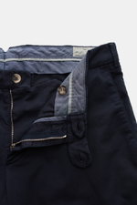 Brunello Cucinelli Chinos 'Italian Fit' navy shown close-up from above with open zip, buttons, and inner waistband detailing. These chinos from luxury label BRUNELLO CUCINELLI are a versatile classic trouser model that can be combined in a variety of ways