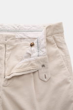 Close-up front view of Brunello Cucinelli Corduroy pants sand, showcasing pure cotton corduroy, soft feel, garment dyed fabric, zipper, waistband buttons, and classic single pleat.