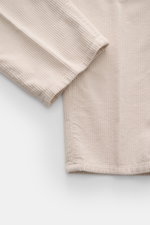 Brunello Cucinelli Corduroy pants sand shown from a close-up top-side angle, highlighting soft pure cotton corduroy texture.