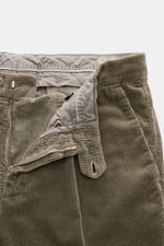 Close-up front view of Brunello Cucinelli Corduroy pants sage, showing zipper, waistband buttons, soft pure cotton fabric, and garment-dyed finish.