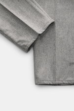 Close-up front view of Brunello Cucinelli wool trousers light grey melange showing soft virgin wool fabric with single pleat and neat hem.