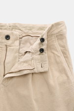 Close-up from the front top view of Incotex Corduroy Pants Beige showing cotton corduroy, slightly elastic quality, soft touch, regular fit, very tapered, zip fly, double waistband pleat, French pockets, and piped back pockets with button.