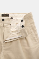 Close-up top-front view of Incotex Cotton trousers sand showing zipper, waistband button, double waistband pleat, tonal stitching, twill made of slightly elastic cotton, soft brushed quality, tapered fit with narrow tapering, french pockets, and back pock