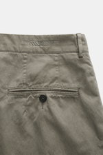 Massimo Osti Studio Trousers grey green shown from the back waist, featuring mix of cotton and microfiber, smooth touch, loose fit, straight cut, button fly, small watch pocket, double waistband pleat, piped pockets, back pockets with flap and button, and