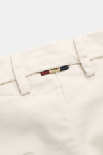 Close-up view of Mason's Chino 'Torinostyle' cream waistband, showing mix of modal, cotton, microfiber, soft touch, slim tapered fit, zipper and waistband buttons, French pockets, piped back pockets with button, and typical metal initial.