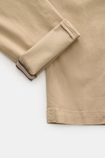 Close-up, top-down view of the beige Mason's Chino 'Torinostyle' showing folded cuff, made from mix of modal, cotton and microfiber, soft touch, slim and tapered fit, featuring zipper and waistband buttons, French pockets, piped back pockets with button, 