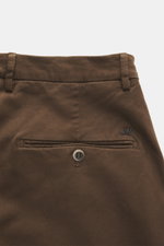 Close-up rear view of Mason's Chino 'Torinostyle' brown pants showing piped back pockets with button, typical metal initial, slim tapered fit, zipper and waistband buttons, made from a soft touch mix of modal, cotton, and microfiber with French pockets.