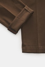 Close-up front view of Mason's Chino 'Torinostyle' brown pants cuff, showing slim, tapered fit with mix of modal, cotton, microfiber, soft touch, zipper and waistband buttons, French pockets, piped back pockets with button, and typical metal initial.