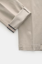 Close-up view of Mason's Chino 'Torinostyle' grey fabric showing the soft touch mix of modal, cotton, and microfiber, slim tapered fit with zipper, waistband buttons, french pockets, piped back pockets with button, and typical metal initial.