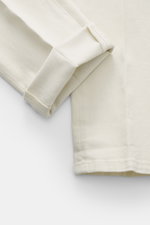 Dondup Chino 'Gaubert' creme, Nahaufnahme der aufgeschlagenen Hose, Mix aus Baumwolle und Lyocell, Slim Fit, elastisch, schmal geschnittene Wade.