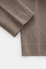 Close-up front view of GTA Corduroy Pants 'Davide' taupe in cotton corduroy with elastic quality, smooth touch, regular fit, slightly tapered leg, zipper and waistband button, internal elastic band, French pockets, small logo detail, and back pockets with