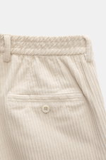 Close-up front view of GTA Corduroy Pants 'Davide' sand, showing cotton corduroy fabric with stretch quality, smooth touch, regular fit, slightly tapered, zipper and waistband button, internal elastic band, French pockets, small logo detail, and back pock