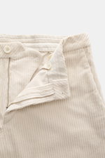 Close-up front view of GTA Corduroy Pants 'Davide' sand in cotton corduroy, showing zipper, waistband button, internal elastic band, smooth touch, stretch quality, regular fit, slightly tapered design.