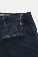 Close-up front view of GTA Corduroy Pants 'Davide' navy showing zipper, waistband button, internal elastic band, corduroy made of cotton with elastic quality, smooth touch, regular fit, slightly tapered, French pockets, small logo detail, and back pockets
