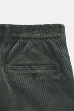 Close-up top view of GTA Corduroy Pants 'Davide' dark grey showing cotton corduroy fabric, stretch quality, smooth touch, regular fit, slightly tapered design, zipper and waistband button, internal elastic band, French pockets, small logo detail, and back