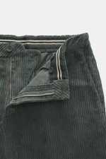 Close-up front view of GTA Corduroy Pants 'Davide' dark grey in cotton corduroy with stretch quality, smooth touch, regular fit, slightly tapered, zipper and waistband button, internal elastic band, French pockets, small logo detail, and back pockets with