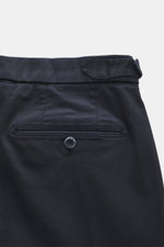 Close-up rear view of GTA Chino 'Herrick' navy pants showing elastic cotton fabric, soft touch, regular fit, low rise, zipper and waistband button, elastic insert in waistband, side adjuster, double waistband pleat, French pockets, and back pockets with b
