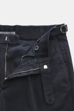 Close-up front view of GTA Chino 'Herrick' navy pants showing elastic cotton, soft touch, regular fit, low rise, zipper and waistband button, elastic insert in waistband, side adjuster, double waistband pleat, French pockets, and back pockets with button.