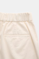 Close-up rear view of 04651/ A trip in a bag Black Corduroy Pants in cream, showing soft cotton corduroy, waistband, and welt pocket.

<p>These corduroy pants by 04651/ A TRIP IN A BAG are made of cotton corduroy with a seersucker backside, providing sp
