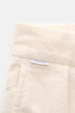 Close-up front view of the waistband and label of 04651/ A trip in a bag Black Corduroy Pants in soft cotton corduroy, showing texture and stitching.