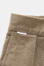 Close-up top view of 04651/ A trip in a bag Corduroy Pants brown waistband showing soft cotton corduroy texture with label.