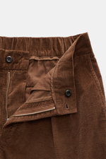 Close-up front view of brown corduroy zipper and button waistband of 04651/ A trip in a bag Corduroy Pants navy, made of soft cotton corduroy with seersucker inner side for comfort, featuring slim fit, ankle length, slightly tapered legs, French and welt 