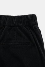 Close-up front view of 04651/ A trip in a bag Black Corduroy Pants waistband, showing soft cotton corduroy, slim fit, and pleats.

<p>These corduroy pants by 04651/ A TRIP IN A BAG are made of cotton corduroy with a seersucker backside, providing special 