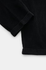 Close-up top-down view of the cuffed hem of 04651/ A trip in a bag Black Corduroy Pants made of soft cotton corduroy with seersucker inner side for comfort.