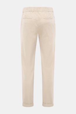 Rear view of 04651/ A trip in a bag Corduroy pants sand in wide cotton corduroy with seersucker inside, featuring regular fit, tapered legs, waistband button, zipper, partially elastic waistband, side seam pockets, double waistband pleat, welt back pocket