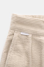 Close-up front view of 04651/ A trip in a bag Corduroy pants sand showing soft wide cotton corduroy fabric, waistband, zipper, and pleats.

Description: <p>These corduroy pants by 04651/ A TRIP IN A BAG are made of wide cotton corduroy with a seersucker b