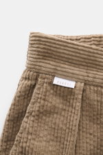 Close-up front view of 04651/ A trip in a bag Corduroy pants taupe, showing soft wide cotton corduroy fabric with seersucker inside for comfort.

Description: These corduroy pants by 04651/ A TRIP IN A BAG are made of wide cotton corduroy with a seersucke