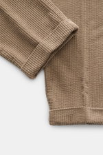 Close-up top-down view of 04651/ A trip in a bag Corduroy pants taupe showing wide cotton corduroy texture with seersucker backing and folded cuff.

Description: <p>These corduroy pants by 04651/ A TRIP IN A BAG are made of wide cotton corduroy with a see