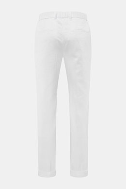 Rear view of 04651/ A trip in a bag Corduroy pants white made of wide cotton corduroy with seersucker backing, regular fit, tapered legs, double waistband pleat, side seam and welt back pockets, zipper, waistband button, partially elastic waistband, and f