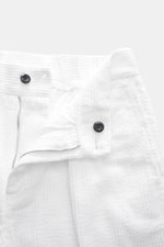 Close-up top-front view of 04651/ A trip in a bag Corduroy pants white, soft wide cotton corduroy with seersucker backing, zipper, button, and waistband details.