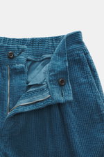 Close-up top view of 04651/ A trip in a bag Corduroy pants smoky blue showing soft cotton corduroy fabric, zipper, button, and seersucker inside for comfort.