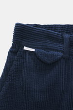 Close-up front view of 04651/ A trip in a bag Corduroy Pants navy, showing soft wide cotton corduroy fabric, waistband, and partial elastic band.

Description: <p>These corduroy pants by 04651/ A TRIP IN A BAG are made from wide cotton corduroy with a see