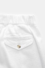 Close-up front view of 04651/ A trip in a bag Corduroy Pants white showing soft wide cotton corduroy, buttoned back flap pocket, and waistband details.