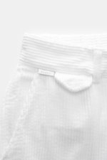 Close-up front view of 04651/ A trip in a bag Corduroy Pants white, made of soft wide cotton corduroy with seersucker backing.