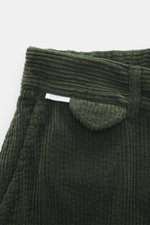 Close-up top view of dark green 04651/ A trip in a bag Corduroy Pants showing soft cotton corduroy texture and waistband details.

Description: <p>These corduroy pants by 04651/ A TRIP IN A BAG are made from wide cotton corduroy with a seersucker back, pr
