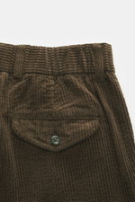 Close-up rear view of 04651/ A trip in a bag Corduroy Pants Dark Brown made of soft wide cotton corduroy with a buttoned flap pocket.