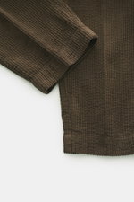 Close-up top-down view of 04651/ A trip in a bag Corduroy Pants Dark Brown showing wide cotton corduroy fabric with seersucker texture.