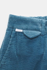 Close-up front top view of 04651/ A trip in a bag Corduroy Pants smoky blue in soft wide cotton corduroy with seersucker inside, showing waistband, button, and partial elastic band.