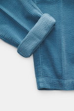 Close-up top-down view of 04651/ A trip in a bag Corduroy Pants smoky blue, showing soft wide cotton corduroy outer and seersucker-backed cuff.

Description: <p>These corduroy pants by 04651/ A TRIP IN A BAG are made from wide cotton corduroy with a seers