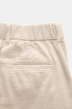 Close-up back view of 04651/ A trip in a bag Cord Cargo Pants Dark Brown in beige corduroy, showing piped back pocket, double waistband pleat, and belt loops. Modern design, highest wearing comfort: the cargo pants in a casual cut by 04651/ A TRIP IN A BA
