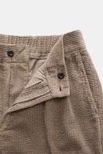 Close-up, front view of 04651/ A trip in a bag Cord Cargo Pants Sand showing corduroy fabric, zipper, button, and waistband details. Modern design, highest wearing comfort: the cargo pants in a casual cut by 04651/ A TRIP IN A BAG made of pure cotton cord