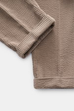 Close-up top view of 04651/ A trip in a bag Cord Cargo Pants Sand showing soft pure cotton corduroy fabric with ribbed texture and cuff.