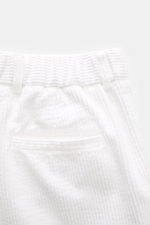 Close-up rear view of 04651/ A trip in a bag Cord Cargo Pants White showing pure cotton corduroy fabric, elastic waistband, and piped back pocket.