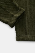 Close-up view of the folded cuff and corduroy fabric texture of 04651/ A trip in a bag Cord Cargo-Jogpants grün showing ribbed cotton detail. Modern design, highest comfort: the hybrid of cargo pants and cool jogpants from 04651/ A TRIP IN A BAG made of s